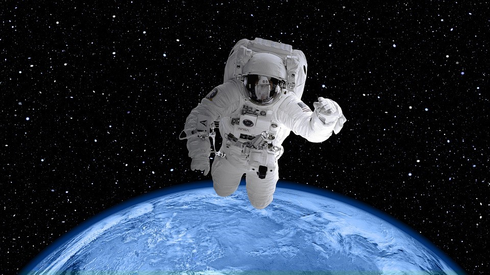 Astronaut on spacewalk with Earth's horizon in background
